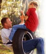 Father and son on tire swing. (Image Credit: Getty Images)