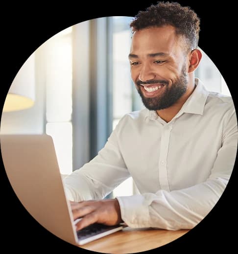 Happy professional working at 
a laptop.