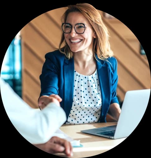 Smiling business women shaking hands with a client.