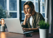 Professional businesswoman researching health insurance options online, highlighting resources for choosing the right coverage plan