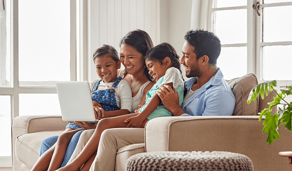 Multi-generational family relaxing on couch at home, representing affordable health insurance coverage for Florida families and individuals