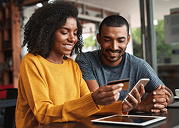 Smiling couple reviewing health insurance plan documents, representing informed decision-making for individual ACA marketplace coverage