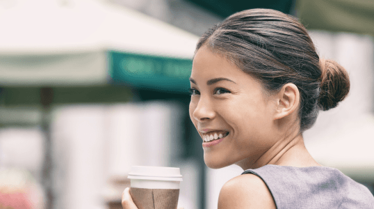 Young professional woman smiling confidently, representing short-term health insurance for individuals between jobs or during life transitions