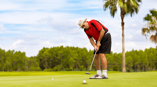 Senior man playing golf on sunny course, exemplifying active retirement lifestyle enabled by Medicare Advantage and supplement coverage